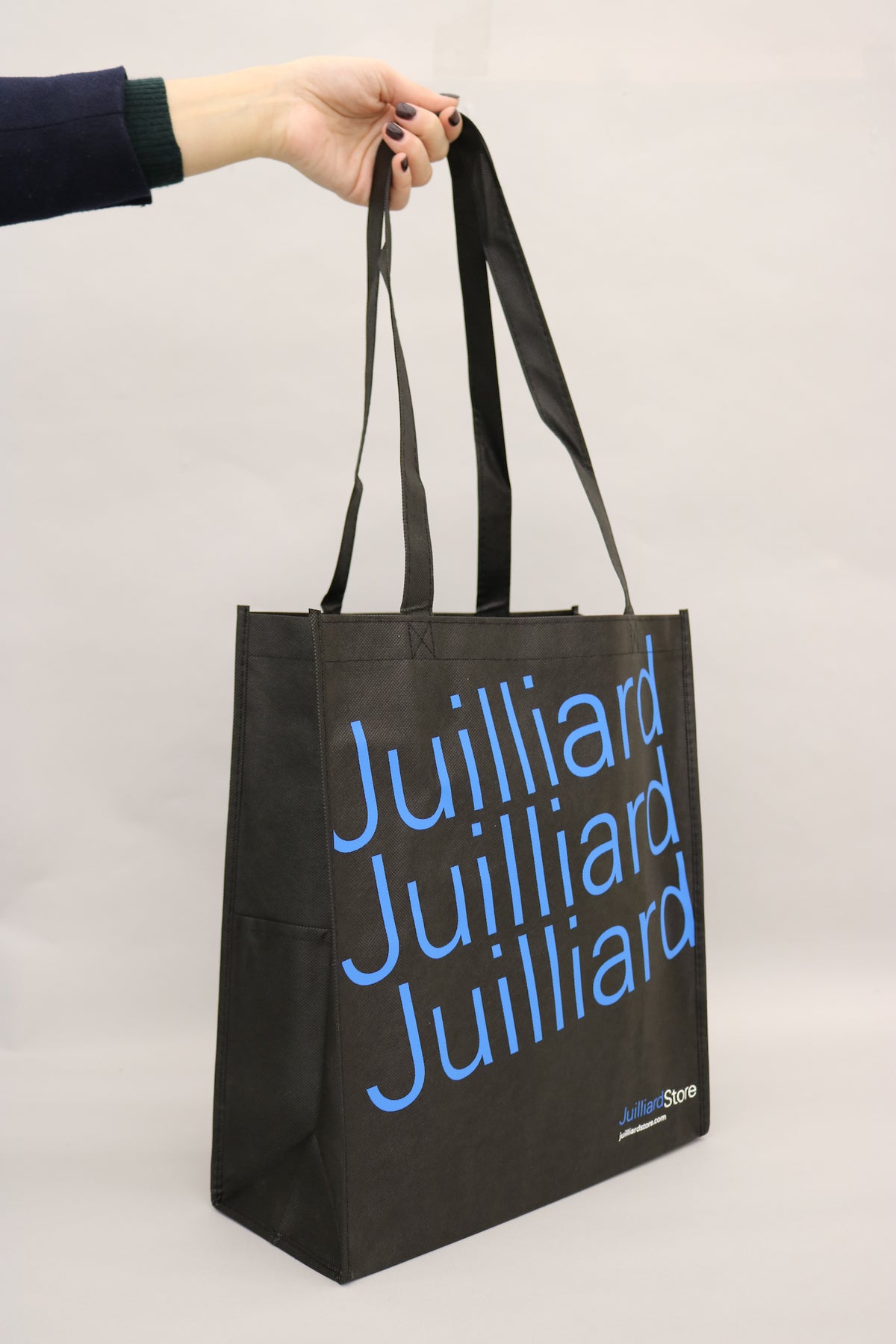 Black reusable tote bag with blue Juilliard logo